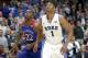Duke forward Jabari Parker and Kansas guard Andrew Wiggins look for a possible rebound off a free-throw attempt during the second half of an NCAA college basketball game Tuesday, Nov. 12, 2013, in Chicago. Kansas won 94-83. (AP Photo/Charles Rex Arbogast)