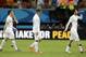 England's Leighton Baines, left, Wayne Rooney and Adam Lallana leave the pitch after the group D World Cup soccer match between England and Italy at the Arena da Amazonia in Manaus, Brazil, Saturday, June 14, 2014. Italy won the match 2-1. (AP Photo/Matt Dunham)
