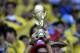 A Columbian fan holds up a replica of the World Cup trophy before the group C World Cup soccer match between Colombia and Greece at the Mineirao Stadium in Belo Horizonte, Brazil, Saturday, June 14, 2014. (AP Photo/Fernando Vergara)