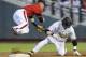 Vanderbilt's Dansby Swanson, right, steals second base against Louisville shortstop Sutton Whiting, left, and advances to third base on a throwing error in the fourth inning of an NCAA baseball College World Series game in Omaha, Neb., Saturday, June 14, 2014. (AP Photo/Dave Weaver)