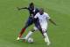 France's Paul Pogba, left and Honduras' Wilson Palacios challenge for the ball during the group E World Cup soccer match between France and Honduras at the Estadio Beira-Rio in Porto Alegre, Brazil, Sunday, June 15, 2014. (AP Photo/Andrew Medichini)