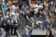 A fan holding a child catches Colorado Rockies shortstop Troy Tulowitzki's two-run home run against the San Francisco Giants during the third inning of a baseball game in San Francisco, Sunday, June 15, 2014. (AP Photo/Jeff Chiu)