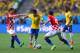 SAO PAULO, BRAZIL - JUNE 12: Neymar of Brazil controls the ball against Nikica Jelavic (L) and Ivan Perisic of Croatia (R) during the 2014 FIFA World Cup Brazil Group A match between Brazil and Croatia at Arena de Sao Paulo on June 12, 2014 in Sao Paulo, Brazil. (Photo by Warren Little/Getty Images)
