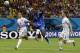 Italy's Mario Balotelli, centre, gets in-between England's Gary Cahill and England's Phil Jagielka, left, during the group D World Cup soccer match between England and Italy at the Arena da Amazonia in Manaus, Brazil, Saturday, June 14, 2014. (AP Photo/Matt Dunham)