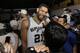 San Antonio Spurs forward Tim Duncan (21) smiles while celebrating in the locker room after Game 5 of the NBA basketball finals against the Miami Heat on Sunday, June 15, 2014, in San Antonio. The Spurs won the NBA championship 104-87. (AP Photo/David J. Phillip)