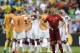 Portugal's Cristiano Ronaldo stands on the pitch as German players celebrate following Portugal's 4-0 loss to Germany during the group G World Cup soccer match between Germany and Portugal at the Arena Fonte Nova in Salvador, Brazil, Monday, June 16, 2014. (AP Photo/Natacha Pisarenko)