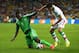 CURITIBA, BRAZIL - JUNE 16: Emmanuel Emenike of Nigeria and Alireza Jahan Bakhsh of Iran battle for the ball during the 2014 FIFA World Cup Brazil Group F match between Iran and Nigeria at Arena da Baixada on June 16, 2014 in Curitiba, Brazil. (Photo by Julian Finney/Getty Images)