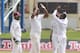 West Indies fast bowler Shannon Gabriel, center, high fives with teammate Jermaine Blackwood, right, as the wicket keeper and captain Denesh Ramdin, left, look on after taking the wicket of New Zealand's Kane Williamson, who was caught by Jason Holder for 42 runs, during the opening day of the second cricket Test match in Port of Spain, Trinidad, Monday, June 16, 2014. (AP Photo/Arnulfo Franco)