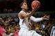 Missouri's Jordan Clarkson drives through Alabama players as he shoots during the first half of an NCAA college basketball game Saturday, Jan. 18, 2014, in Columbia, Mo. (AP Photo/L.G. Patterson)