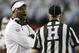 Texas A&M head coach Kevin Sumlin talks with a referee in the first half of the Chick-fil-A Bowl NCAA college football game against Duke Tuesday, Dec. 31, 2013, in Atlanta. (AP Photo/John Bazemore)
