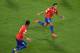 CUIABA, BRAZIL - JUNE 13: Alexis Sanchez of Chile (R) celebrates scoring the team's first goal with Mauricio Isla during the 2014 FIFA World Cup Brazil Group B match between Chile and Australia at Arena Pantanal on June 13, 2014 in Cuiaba, Brazil. (Photo by Stu Forster/Getty Images)