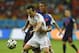 Netherlands' Jonathan de Guzman, right, grabs hold of Spain's David Silva during the group B World Cup soccer match between Spain and the Netherlands at the Arena Ponte Nova in Salvador, Brazil, Friday, June 13, 2014. (AP Photo/Manu Fernandez)