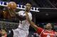 Louisville guard Russ Smith, left, lays the ball up ahead of Houston guard Brandon Morris, right, during the first half of an NCAA college basketball game in the semifinals of the American Athletic Conference men's tournament Friday, March 14, 2014, in Memphis, Tenn. (AP Photo/Mark Humphrey)