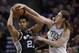 Boston Celtics center Kelly Olynyk, right, fouls San Antonio Spurs forward Tim Duncan (21) as Duncan comes down with the rebound during the second half of an NBA basketball game in Boston, Wednesday, Feb. 12, 2014. The Spurs defeated the Celtics 104-92. (AP Photo/Stephan Savoia)