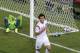 Russia's goalkeeper Igor Akinfeev, left, lies in the goal as South Korea's Koo Ja-cheol celebrates after scoring the opening goal during their group H World Cup soccer match at the Arena Pantanal in Cuiaba, Brazil, Tuesday, June 17, 2014. (AP Photo/Thanassis Stavrakis)