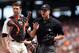 Jun 14, 2014; San Francisco, CA, USA; Home plate umpire Chris Segal (96) calls a San Francisco Giants trainer after being hit behind catcher Buster Posey (28) against the Colorado Rockies during the eighth inning at AT&T Park. Mandatory Credit: Kelley L Cox-USA TODAY Sports