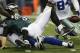 Philadelphia Eagles quarterback Nick Foles (9) fumbles the ball as he is sacked by Dallas Cowboys defensive tackle Jason Hatcher (97) during the second half of an NFL football game, Sunday, Dec. 29, 2013, in Arlington, Texas. (AP Photo/Tim Sharp)
