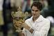 Roger Federer of Switzerland celebrates with the trophy after winning the men's singles final against Andy Murray of Britain at the All England Lawn Tennis Championships at Wimbledon, England, Sunday, July 8, 2012. (AP Photo/Anja Niedringhaus)