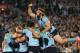 SYDNEY, AUSTRALIA - JUNE 18: Aaron Woods (R) of the Blues jumps onto his team mates to celebrate a try by Trent Hodkinson during game two of the State of Origin series between the New South Wales Blues and the Queensland Maroons at ANZ Stadium on June 18, 2014 in Sydney, Australia. (Photo by Mark Metcalfe/Getty Images)