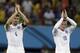 England's Steven Gerrard, left, and Wayne Rooney applaud spectators after the group D World Cup soccer match between England and Italy at the Arena da Amazonia in Manaus, Brazil, Saturday, June 14, 2014. Italy won the match 2-1. (AP Photo/Martin Mejia)