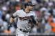 Minnesota Twins' Brian Dozier rounds first base after hitting a two-run home run against the Detroit Tigers in the ninth inning of a baseball game in Detroit, Saturday, June 14, 2014. (AP Photo/Paul Sancya)