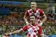 Croatia's Mario Mandzukic (17) celebrates with teammate Ivan Perisic after scoring his side's fourth goal during the group A World Cup soccer match between Cameroon and Croatia at the Arena da Amazonia in Manaus, Brazil, Wednesday, June 18, 2014. (AP Photo/Martin Mejia)
