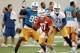 Miami Dolphins quarterback Ryan Tannehill, foreground, looks for an open teammate during mini-camp, Tuesday, June 17, 2014 at the Dolphins Training Facility in Davie, Fla. defensive end Dion Jordan (95) and tackle Branden Albert (71) are at rear. (AP Photo/Wilfredo Lee)