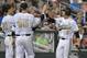 Vanderbilt's Rhett Wiseman (8) is greeted by Tyler Ferguson (45) and Bryan Reynolds (20) after he scored a run against UC Irvine on a single by John Norwood in the seventh inning of an NCAA baseball College World Series game in Omaha, Neb., Monday, June 16, 2014. (AP Photo/Ted Kirk)