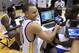 Golden State Warriors' Stephen Curry, center, laughs as he interviews Charles Jenkins at a social media hub during NBA basketball media day at the team's training facility in Oakland, Calif., Monday, Dec. 12, 2011. (AP Photo/Jeff Chiu)