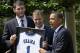 Jon Scheyer hands President Obama his honorary jersey following the 2010 NCAA championship.