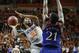 Oklahoma State guard Marcus Smart (33) shoots in front of Kansas center Joel Embiid (21) in the second half of an NCAA college basketball game in Stillwater, Okla., Saturday, March 1, 2014. Oklahoma State won 72-65. (AP Photo/Sue Ogrocki)