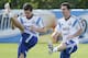 Argentina's Fernando Gago, left, and teammate Lionel Messi warm up at a training session in Vespasiano, near Belo Horizonte, Brazil, Wednesday, June 18, 2014. Argentina plays in group F of the 2014 soccer World Cup. (AP Photo/Victor R. Caivano)