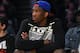Kansas center Joel Embiid watches the Los Angeles Lakers play the Memphis Grizzlies in an NBA basketball game, Sunday, April 13, 2014, in Los Angeles. The Grizzlies won 102-90. (AP Photo/Mark J. Terrill)