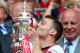 LONDON, ENGLAND - MAY 17: Captain Thomas Vermaelen of Arsenal (R) kisses the trophy in celebration as FA chairman Greg Dyke looks on after the FA Cup with Budweiser Final match between Arsenal and Hull City at Wembley Stadium on May 17, 2014 in London, England. (Photo by Clive Mason/Getty Images)