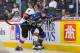 CALGARY, AB - MARCH 15: Kenton Helgesen #3 of the Calgary Hitmen checks Sam Reinhart #23 of the Kootenay Ice during a WHL game at Scotiabank Saddledome on March 15, 2014 in Calgary, Alberta, Canada. (Photo by Derek Leung/Getty Images)