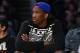 Kansas center Joel Embiid watches the Los Angeles Lakers play the Memphis Grizzlies in an NBA basketball game, Sunday, April 13, 2014, in Los Angeles. The Grizzlies won 102-90. (AP Photo/Mark J. Terrill)