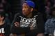Kansas center Joel Embiid watches the Los Angeles Lakers play the Memphis Grizzlies in an NBA basketball game, Sunday, April 13, 2014, in Los Angeles. The Grizzlies won 102-90. (AP Photo/Mark J. Terrill)