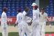 West Indies bowler Kemar Roach, center, celebrates with teammates after taking the wicket of New Zealand's Mark Craig who was caught behind by West Indies' Denesh Ramdin for 67 runs during the second innings on the last day of their second cricket Test match in Port of Spain, Trinidad, Friday, June 20, 2014. (AP Photo/Arnulfo Franco)