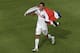 Costa Rica's Jose Miguel Cubero celebrates with his country's flag after winning the group D World Cup soccer match between Italy and Costa Rica at the Arena Pernambuco in Recife, Brazil, Friday, June 20, 2014. (AP Photo/Hassan Ammar)