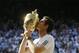 Andy Murray of Britain poses with the trophy after defeating Novak Djokovic of Serbia during the Men's singles final match at the All England Lawn Tennis Championships in Wimbledon, London, Sunday, July 7, 2013. (AP Photo/Kirsty Wigglesworth)