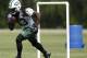 New York Jets running back Chris Ivory runs with the ball through an obstacle during an NFL football organized team activity, Wednesday, June 4, 2014, in Florham Park, N.J. (AP Photo/Julio Cortez)