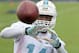Miami Dolphins wide receiver Jarvis Landry catches a ball from a football throwing machine during NFL football mini camp, Wednesday, June 18, 2014, in Davie, Fla. (AP Photo/Wilfredo Lee)