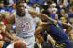 Kansas center Joel Embiid (21) pushes off West Virginia forward Devin Williams, right, during the first half of an NCAA college basketball game in Lawrence, Kan., Saturday, Feb. 8, 2014. Embiid scored 11 points in the game. Kansas defeated West Virginia 83-69. (AP Photo/Orlin Wagner)