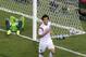 Russia's goalkeeper Igor Akinfeev, left, lies in the goal as South Korea's Koo Ja-cheol celebrates after scoring the opening goal during their group H World Cup soccer match at the Arena Pantanal in Cuiaba, Brazil, Tuesday, June 17, 2014. (AP Photo/Thanassis Stavrakis)