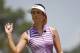 Michelle Wie waves after making a putt on the fifth hole during the third round of the U.S. Women's Open golf tournament in Pinehurst, N.C., Saturday, June 21, 2014. (AP Photo/John Bazemore)