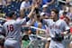 Virginia's Brandon Downes, right, celebrates with Nate Irving (18) after he scored against Mississippi on a two-run single by Robbie Coman in the fourth inning of an NCAA College World Series baseball game in Omaha, Neb., Saturday, June 21, 2014. (AP Photo/Ted Kirk)