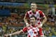 Croatia's Mario Mandzukic (17) celebrates with teammate Ivan Perisic after scoring his side's fourth goal during the group A World Cup soccer match between Cameroon and Croatia at the Arena da Amazonia in Manaus, Brazil, Wednesday, June 18, 2014. (AP Photo/Martin Mejia)
