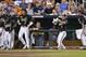 Vanderbilt payers Ro Coleman (1), Dansby Swanson (7), Tyler Beede (11) and Brian Miller, right, cheer on teammate Zander Wiel, unseen, after he scored in the fifth inning on a hit by Rhett Wiseman in the fifth inning of an NCAA baseball College World Series game against Texas in Omaha, Neb., Saturday, June 21, 2014. (AP Photo/Ted Kirk)