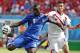 Italy's Mario Balotelli, left, gets in a shot despite the challenge of Costa Rica's Oscar Duarte during the group D World Cup soccer match between Italy and Costa Rica at the Arena Pernambuco in Recife, Brazil, Friday, June 20, 2014. (AP Photo/Frank Augstein)