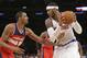 Washington Wizards' Trevor Ariza (1) defends New York Knicks' Carmelo Anthony (7) during the first half of an NBA basketball game Friday, April 4, 2014, in New York. (AP Photo/Frank Franklin II)